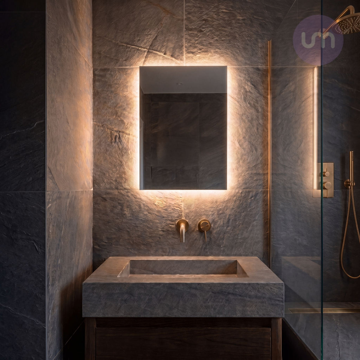Tempus 400 x 600mm backlit LED bathroom mirror glowing warm white 2700K above a stone basin in a slate bathroom